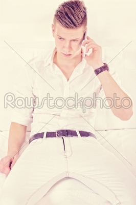 modern fashion guy in white talking on the phone