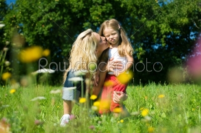 Mother and daughter in the grass