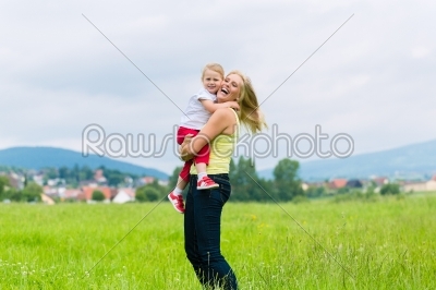 Mother and daughter on a summer meadow