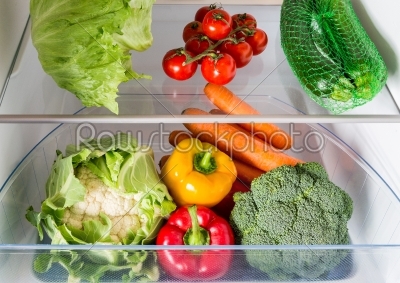 Open fridge filled with fruits and vegetables