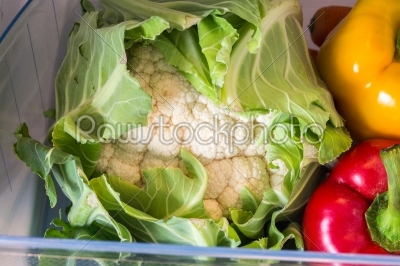 Open fridge filled with fruits and vegetables