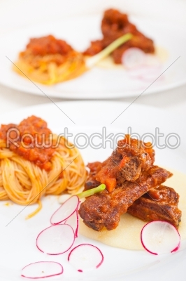pasta with pork ribs sauce on polenta bed