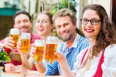 people drinking beer in Bavarian restaurant or pub