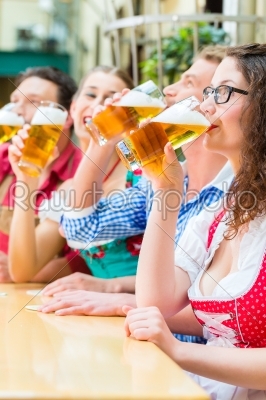 people drinking beer in Bavarian restaurant or pub