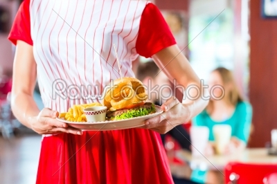 People in American diner or restaurant eating fast food