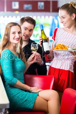 People in American diner or restaurant with wine