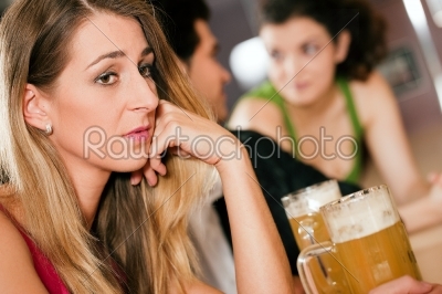 People in bar, woman being abandoned and sad