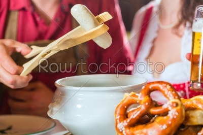People in Bavarian Tracht eating in restaurant or pub