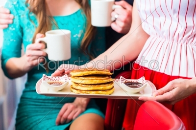 People in diner or restaurant having pancakes