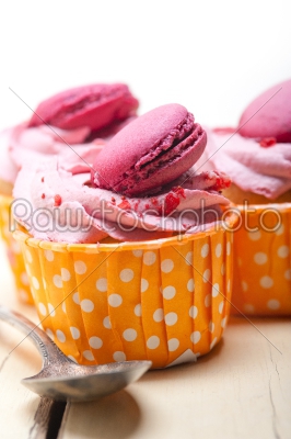 pink berry cream cupcake with macaroon on top