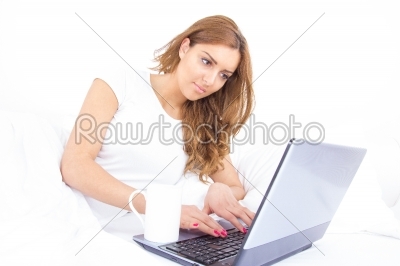 portrait of beautiful young female using a laptop at home
