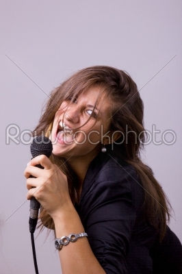 portrait of female singer holding microphone