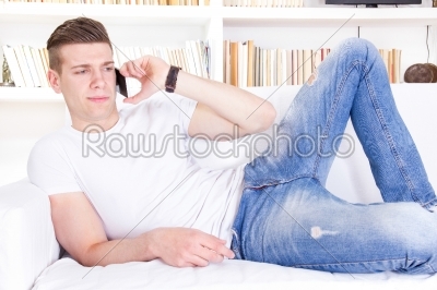 portrait of handsome young man talking on mobile phone