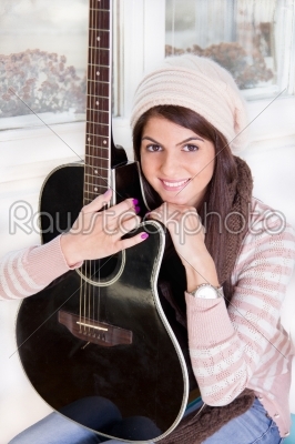 pretty girl holding the guitar