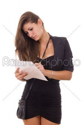 pretty girl in black dress with purse writing down something