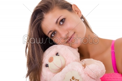 pretty woman holding teddy bear reminding her of childhood