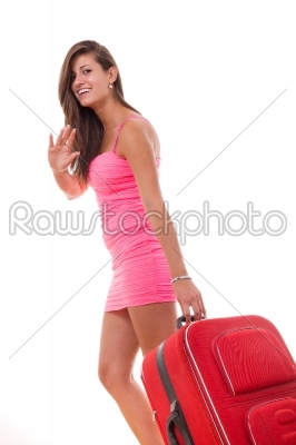 pretty young woman carrying red travel suitcase and smiling