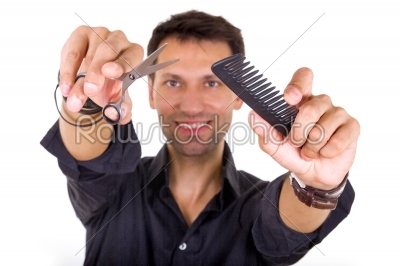 professional hairdresser holding scissors and comb