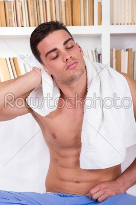 relaxed man drying hair with white towel