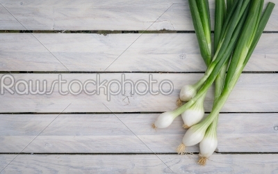 Scallions on a wooden table