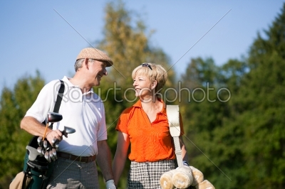 Senior couple playing Golf