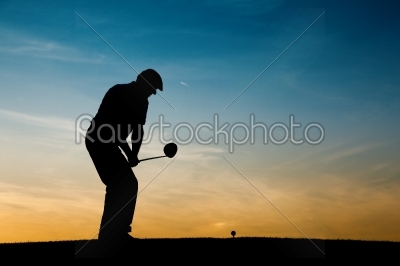 Senior male golf player at sunset
