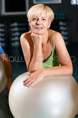 Senior Woman with fitness ball in gym