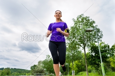 Sports outdoor - young woman running in park