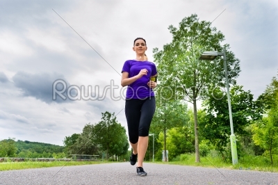 Sports outdoor - young woman running in park