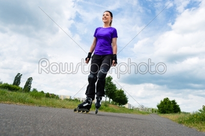 Sports outdoor - young woman skating in park