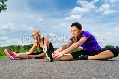 Sports outdoor - young women doing fitness in park