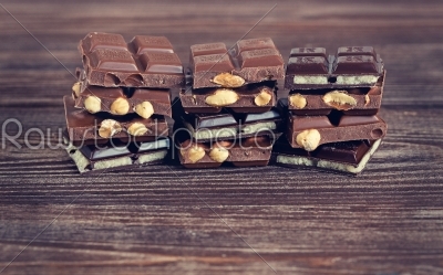 Stack of dark and milk chocolates on wooden table