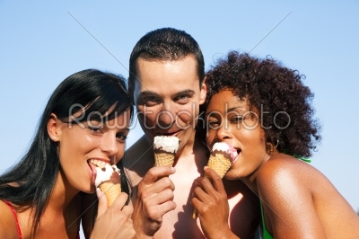 Summer - man and two women eating ice on beach