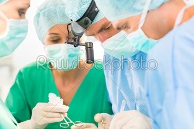 Surgeons operating patient in operation theater