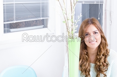 sweet girl smiling while sitting in living room