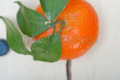 tangerine and blueberry on white table
