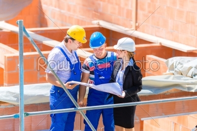 Team discussing construction or building site plans