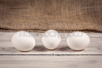 Three eggs on a wooden table