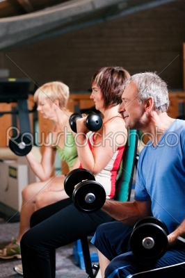 Three senior people in gym