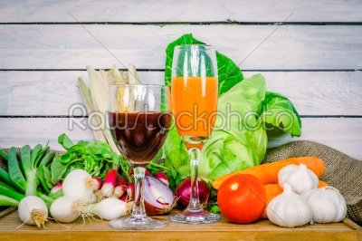 Vegetables on a wooden table with juice