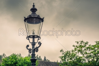 Vintage street lamp in cloudy weather