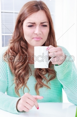 woman disgusting smell of coffee with face expression