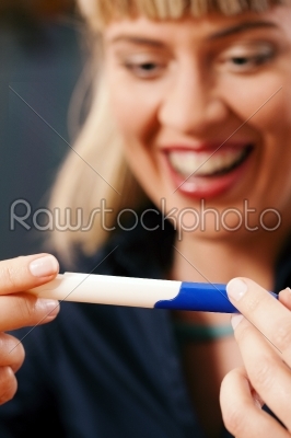 woman doing pregnancy test being happy