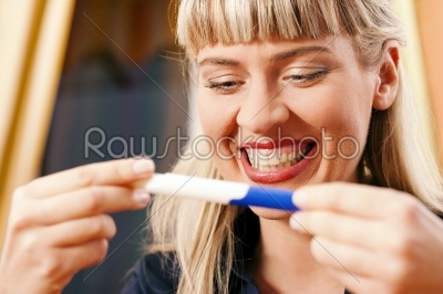 woman doing pregnancy test being happy