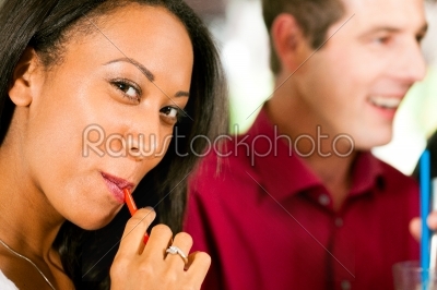 Woman drinking with a straw