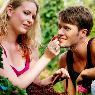 woman feeding him with tomatoe