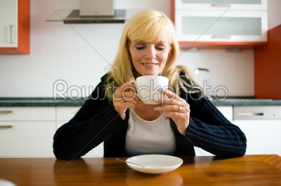 Woman having coffee for breakfast