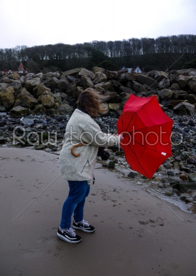 Woman Struggling with an Umbrella