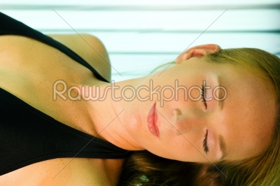 Woman tanning in solarium