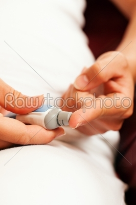 Woman testing glucose for diabetes